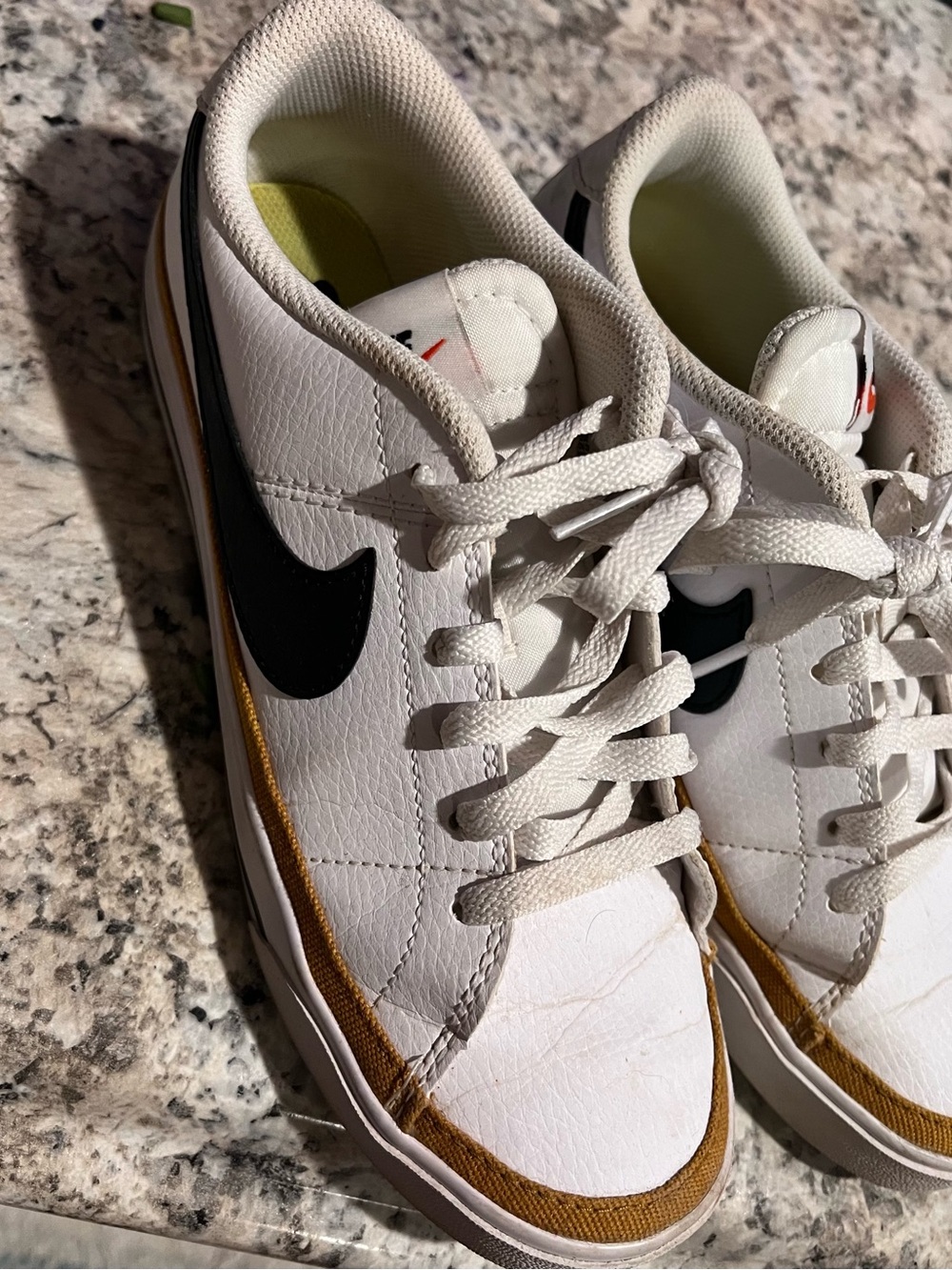 Nike Men’s White Sneakers with Black Swoosh and Gold Trim